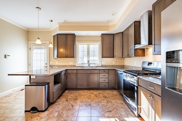 kitchen featuring wall chimney range hood, hanging light fixtures, appliances with stainless steel finishes, light stone counters, and kitchen peninsula