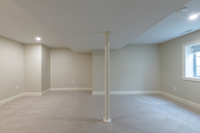 basement featuring light carpet