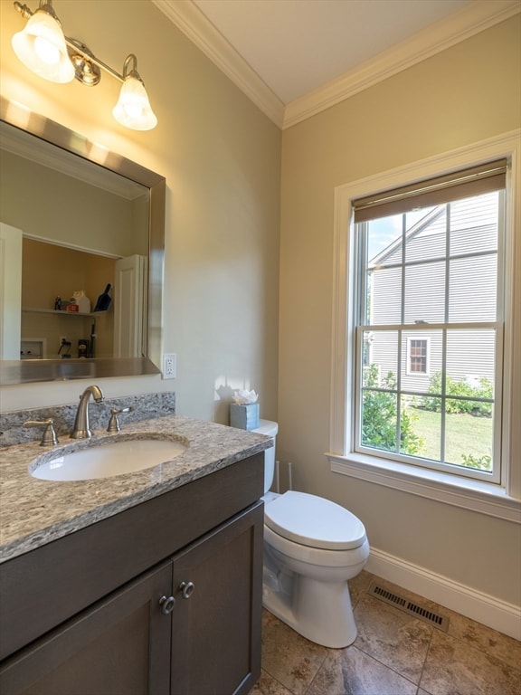 bathroom featuring toilet, vanity, and ornamental molding