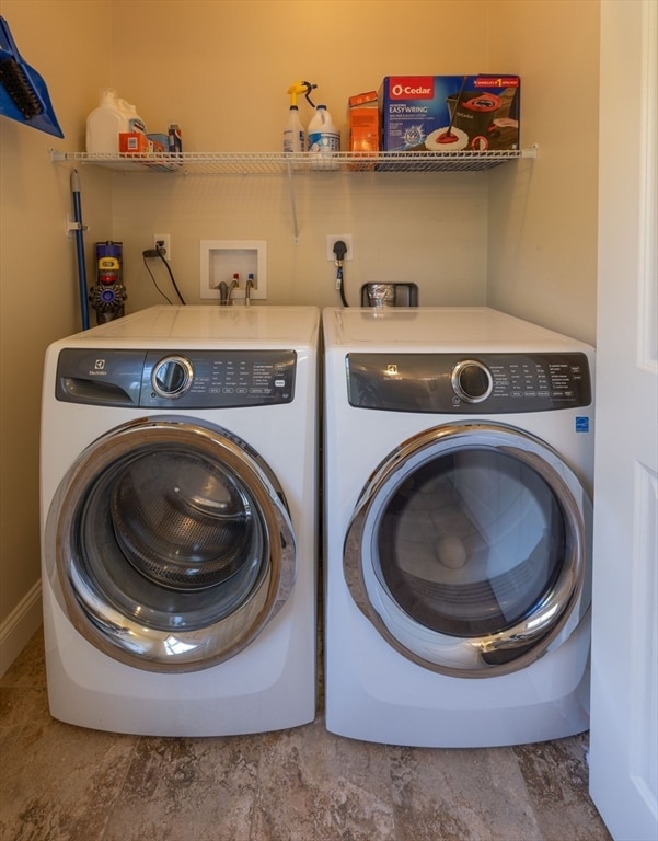 washroom with independent washer and dryer