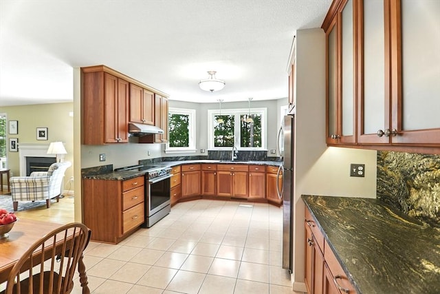 76 Wildflower Cir, Westfield, MA 01085 - kitchen with appliances with stainless steel finishes, under cabinet range hood, dark stone counters, and light tile patterned flooring