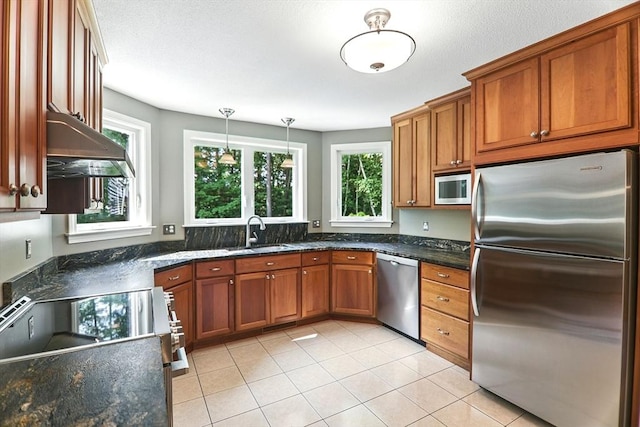 76 Wildflower Cir, Westfield, MA 01085 - kitchen featuring appliances with stainless steel finishes, range hood, brown cabinetry, light tile patterned floors, and pendant lighting