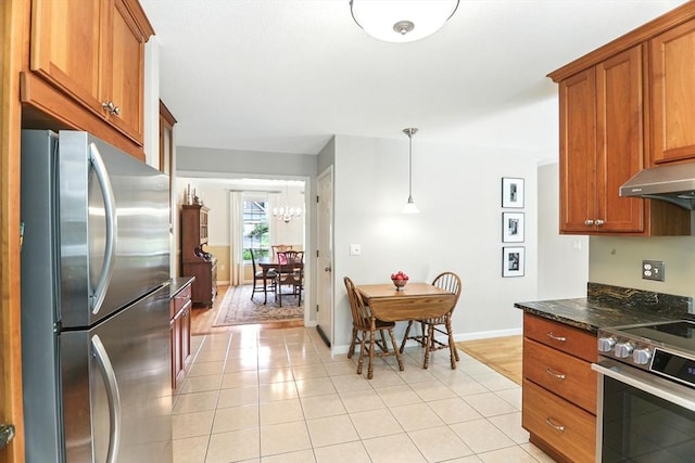 76 Wildflower Cir, Westfield, MA 01085 - kitchen with appliances with stainless steel finishes, brown cabinets, and light tile patterned floors
