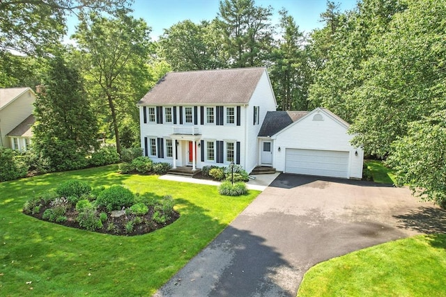 76 Wildflower Cir, Westfield, MA 01085 - colonial house with driveway, a garage, and a front lawn