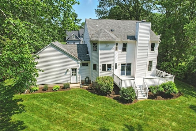 76 Wildflower Cir, Westfield, MA 01085 - rear view of property featuring a chimney, a lawn, a deck, and roof with shingles