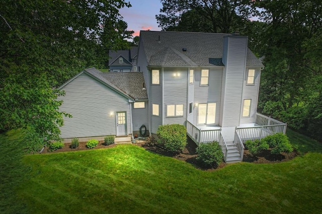 76 Wildflower Cir, Westfield, MA 01085 - back of house with a chimney, a yard, a deck, and roof with shingles