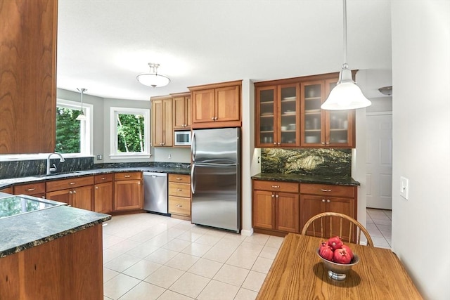 76 Wildflower Cir, Westfield, MA 01085 - kitchen with appliances with stainless steel finishes, brown cabinetry, backsplash, and light tile patterned flooring