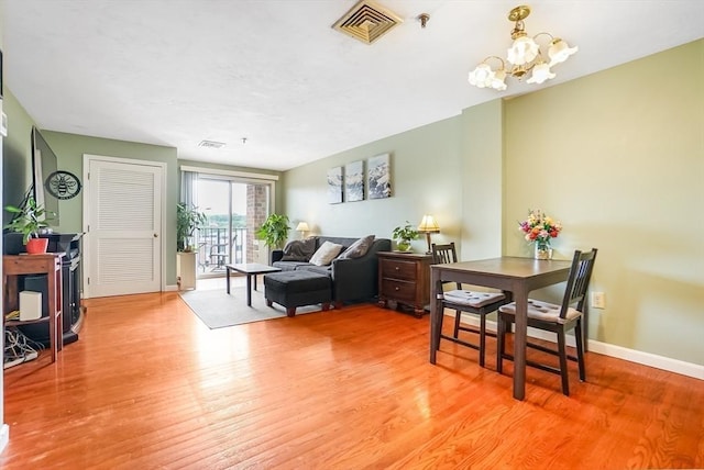 230 Willard St Unit 412, Quincy, MA 02169 - living area featuring light wood finished floors, a chandelier, and baseboards