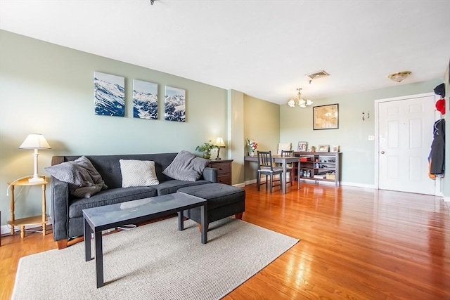 230 Willard St Unit 412, Quincy, MA 02169 - living room featuring a chandelier, light wood-style flooring, and baseboards