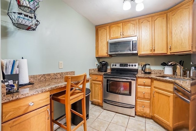 230 Willard St Unit 412, Quincy, MA 02169 - kitchen featuring stainless steel appliances, a sink, light tile patterned flooring, and light stone countertops