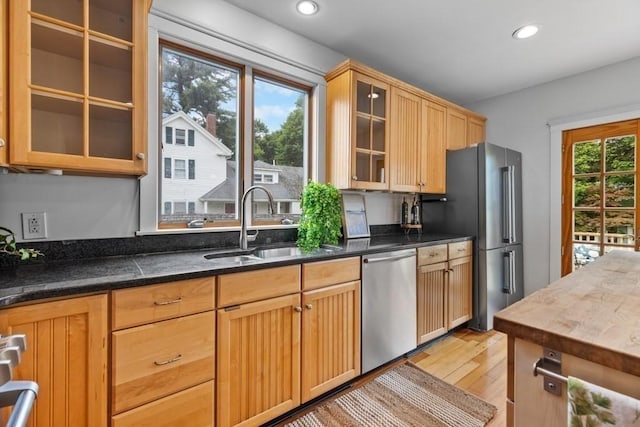 454 Webster St, Needham, MA 02494 - kitchen featuring stainless steel appliances, light wood finished floors, a sink, glass insert cabinets, and recessed lighting