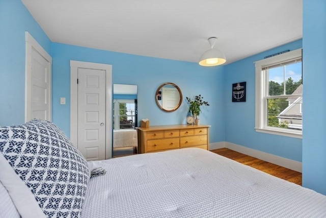 454 Webster St, Needham, MA 02494 - bedroom with baseboards, multiple windows, and wood finished floors