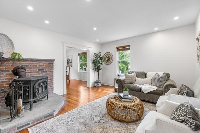 454 Webster St, Needham, MA 02494 - living room featuring light wood-style floors, recessed lighting, a wood stove, and baseboards