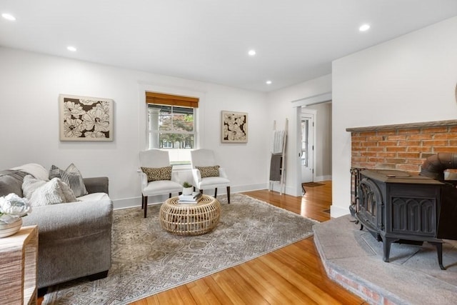 454 Webster St, Needham, MA 02494 - living area featuring wood finished floors, recessed lighting, baseboards, and a wood stove
