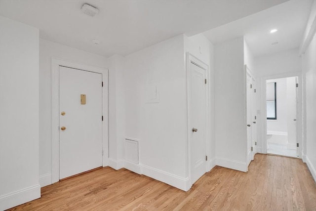 hall with light hardwood / wood-style flooring