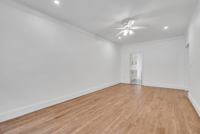 empty room with ornamental molding, ceiling fan, and light hardwood / wood-style flooring