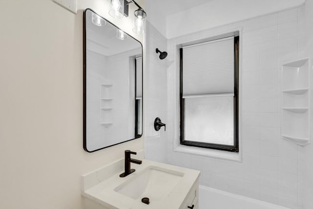 bathroom with vanity and a tub