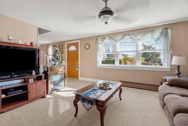 carpeted living room featuring baseboard heating and a textured ceiling