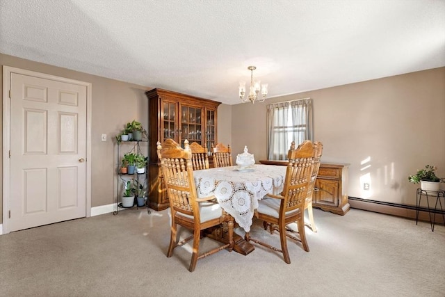 carpeted dining room with a baseboard radiator, a textured ceiling, and a notable chandelier