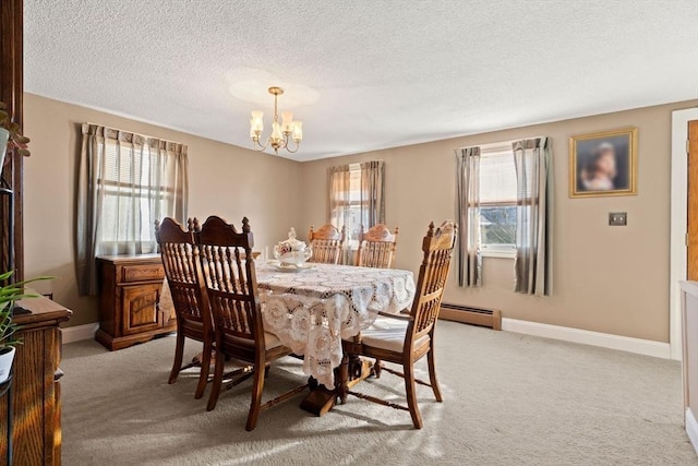 dining area featuring light carpet, a baseboard heating unit, a textured ceiling, and a notable chandelier