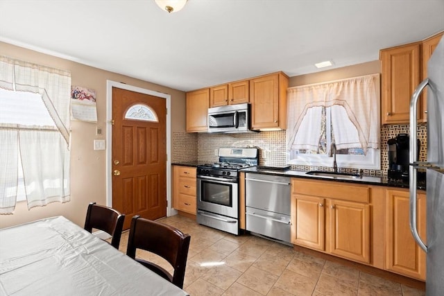 kitchen featuring decorative backsplash, light tile patterned flooring, sink, and stainless steel appliances