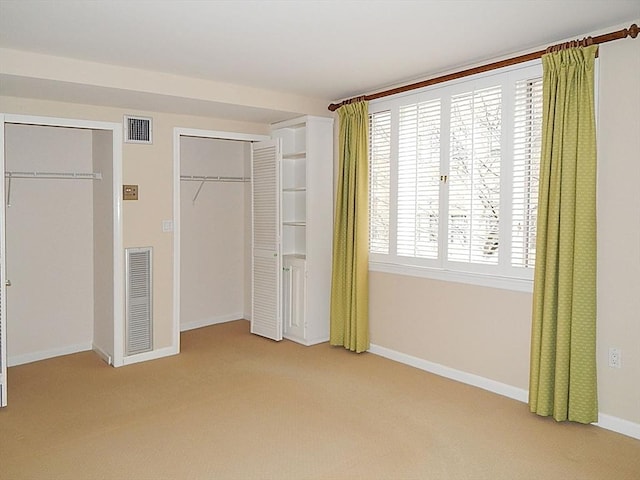 unfurnished bedroom with light colored carpet