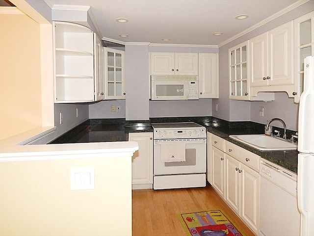 kitchen featuring white cabinetry, sink, white appliances, and light hardwood / wood-style flooring