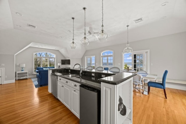 306 Millway, Barnstable, MA 02630 - kitchen featuring a sink, open floor plan, vaulted ceiling, light wood-style flooring, and a kitchen island with sink