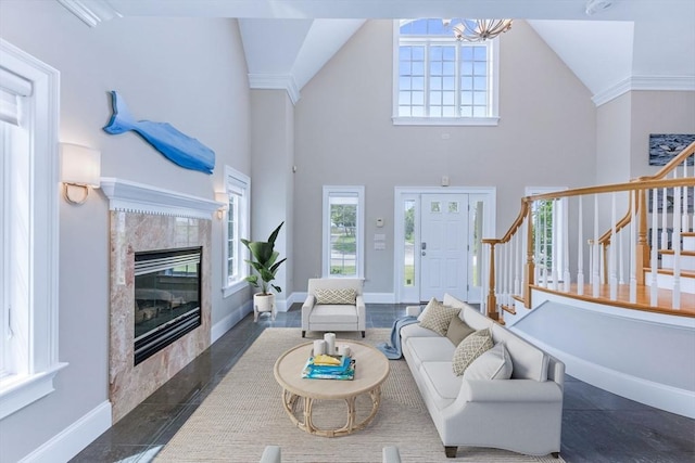 306 Millway, Barnstable, MA 02630 - living area featuring stairway, a chandelier, a fireplace, baseboards, and high vaulted ceiling