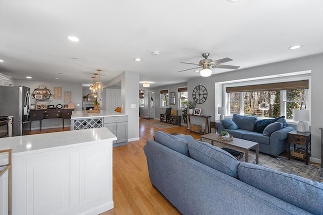 living area with recessed lighting, a wealth of natural light, and ceiling fan