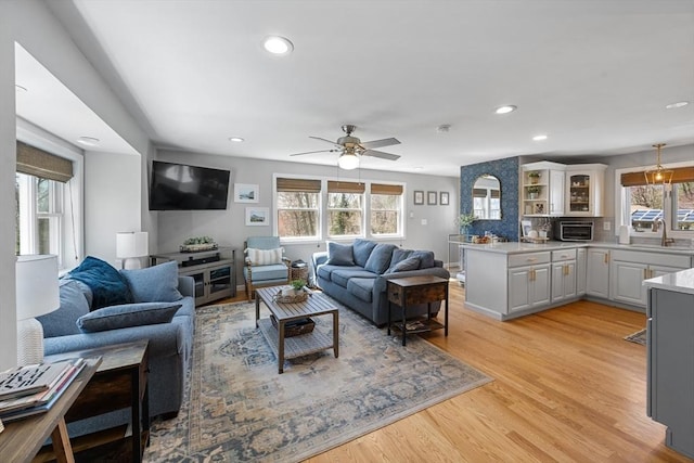 living room with light wood-style flooring, a toaster, recessed lighting, and ceiling fan