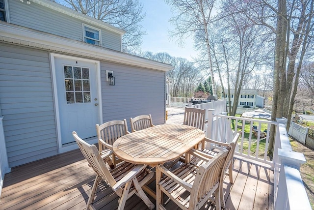 wooden deck with fence and outdoor dining area