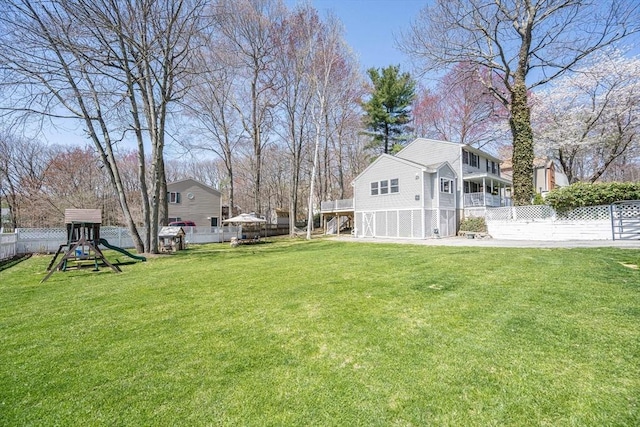 view of yard with a fenced backyard and a playground
