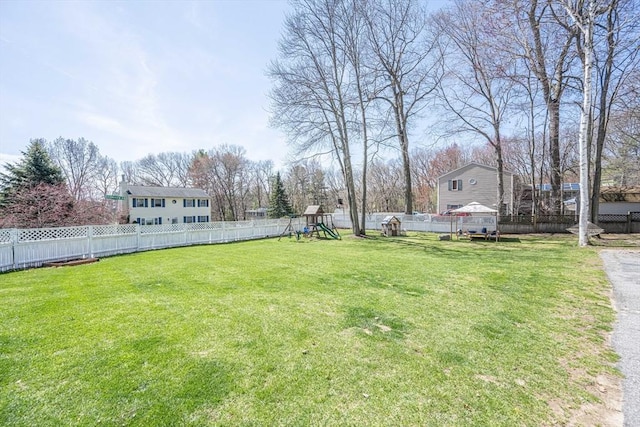 view of yard featuring a fenced backyard and a playground