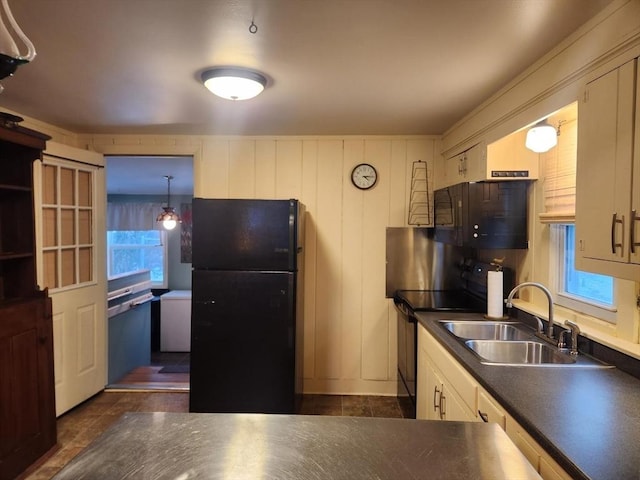 kitchen with decorative light fixtures, sink, white cabinets, and black appliances