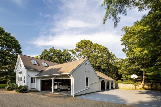41 Cobbs Hill Rd, Chilmark, MA 02535 - view of side of home featuring fence and an attached garage