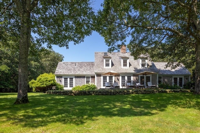 41 Cobbs Hill Rd, Chilmark, MA 02535 - cape cod-style house featuring a front lawn, a chimney, and a patio area