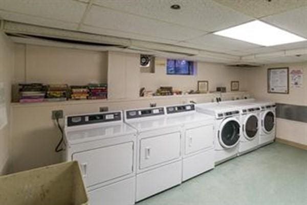shared laundry area featuring washing machine and dryer and a sink