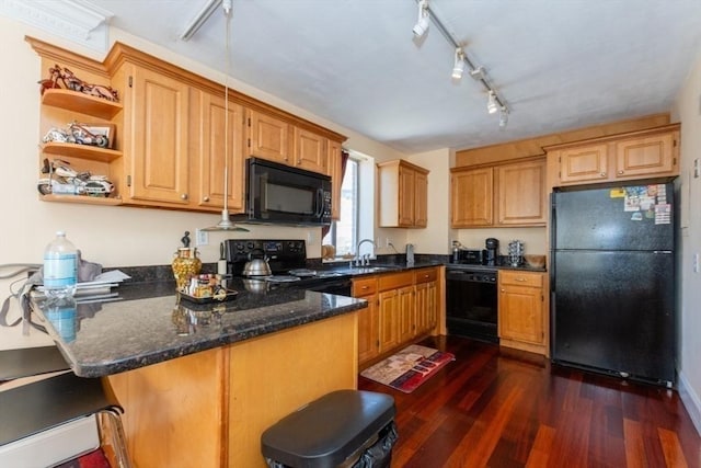 kitchen featuring dark wood-type flooring, black appliances, rail lighting, and a peninsula