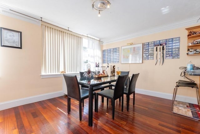 dining area with crown molding, wood finished floors, and baseboards