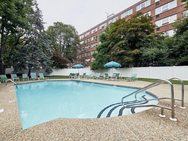 pool featuring a patio area and fence