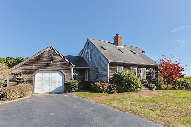 cape cod-style house featuring a garage and a front yard