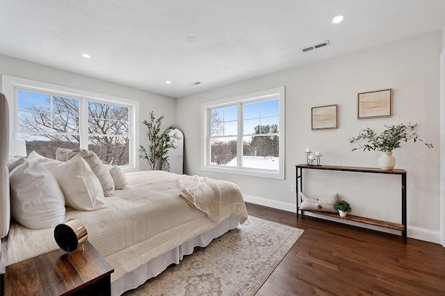 bedroom with dark hardwood / wood-style flooring