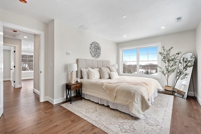 bedroom with dark wood-type flooring