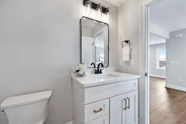 bathroom featuring hardwood / wood-style flooring, vanity, and toilet