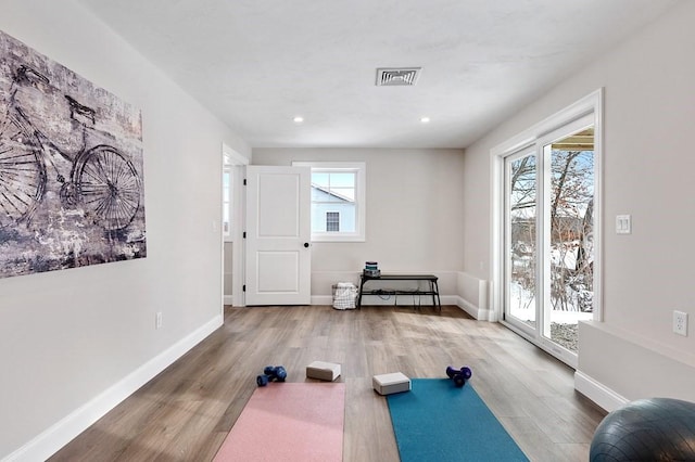 workout area with hardwood / wood-style floors