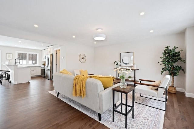 living room with dark wood-type flooring and sink