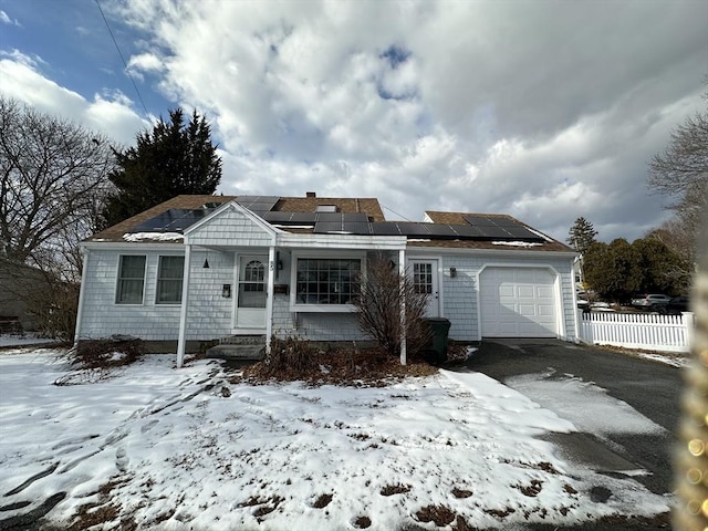 view of front of house featuring a garage and solar panels