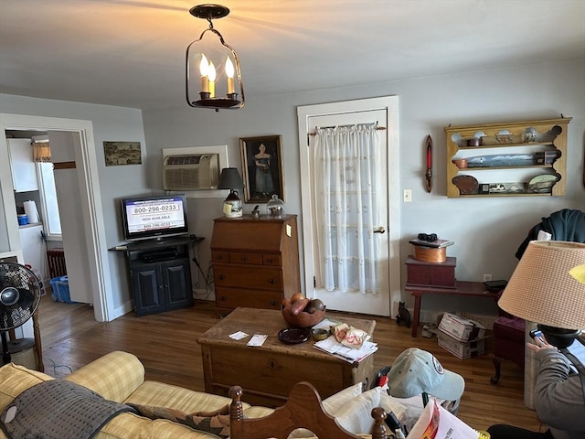 living room featuring dark hardwood / wood-style flooring and a wall unit AC