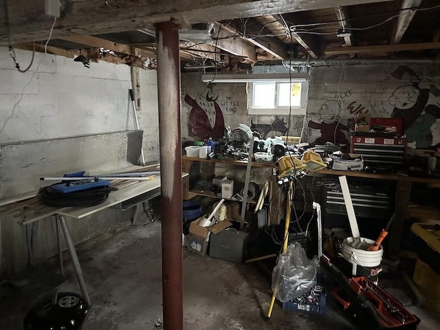 miscellaneous room featuring a workshop area and concrete floors